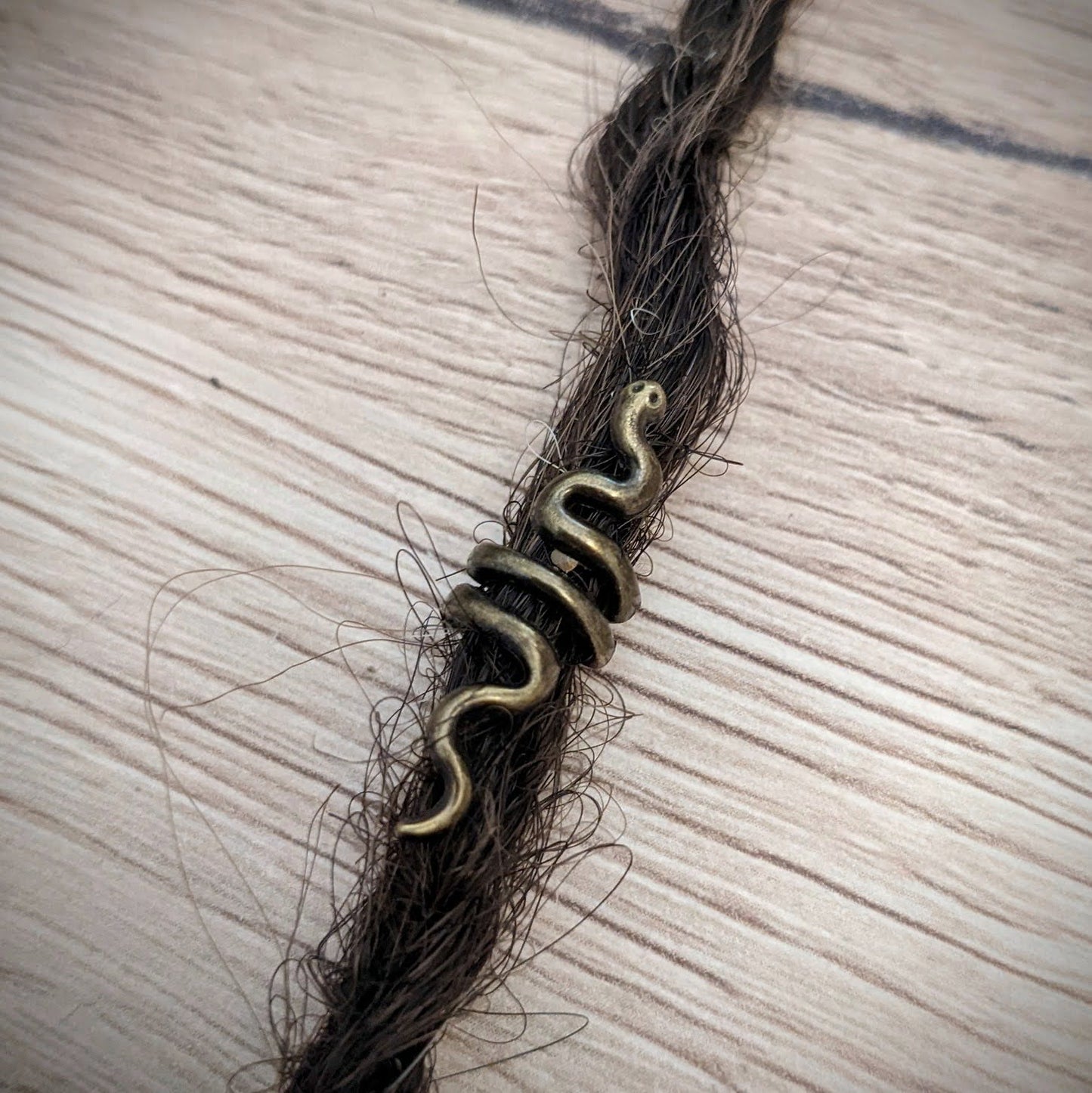 Small metal snake beads